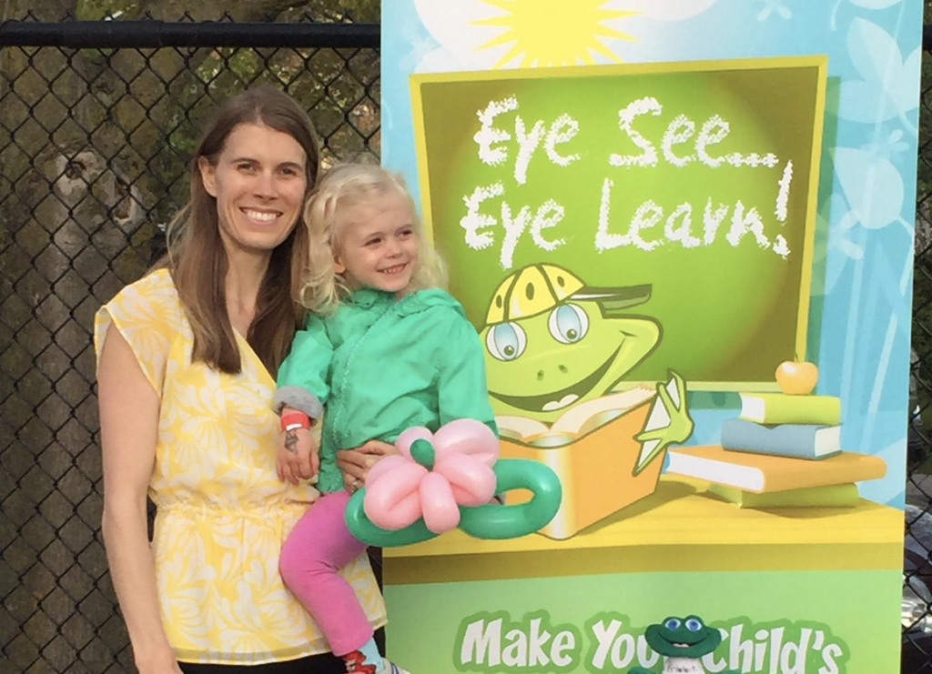 Dr. Karen Stafford with her daughter, a sign saying "Eye See...Eye Learn" program